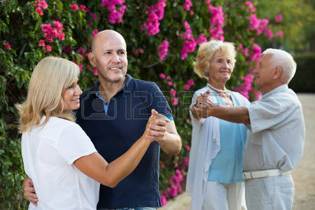 91808738-happy-mature-parents-with-adult-children-dancing-in-sum.jpg